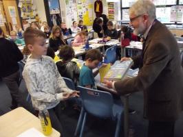 Michael Walker presenting a dictionary at St. Michael's Primary School